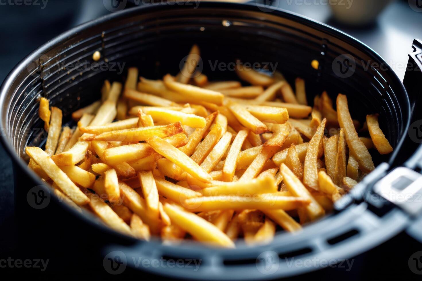 French fries cooking in an air fryer basket photo