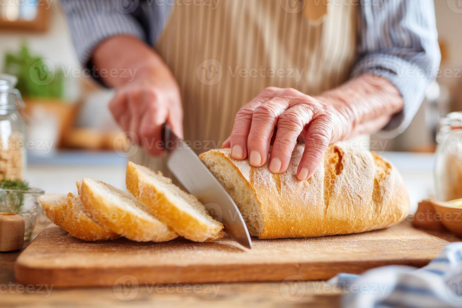 Senior woman slicing fresh bread on wooden cutting board photo