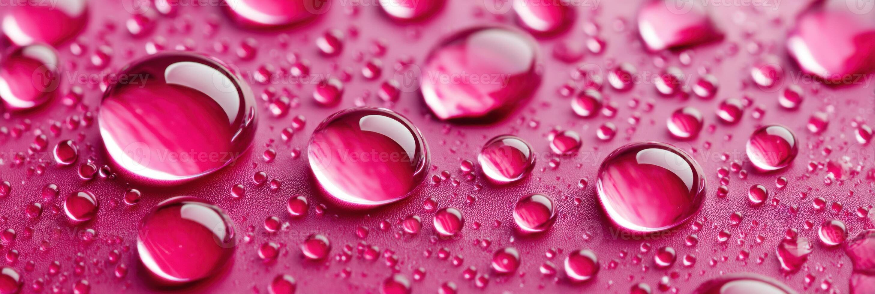 Vibrant fuchsia water drops creating a beautiful pattern on glass material photo