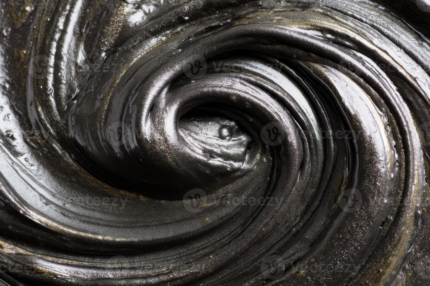 Thick black slime swirling and creating concentric circles photo