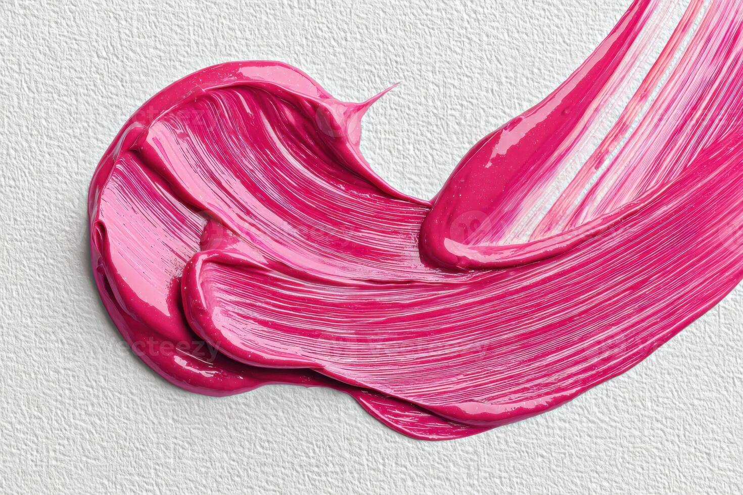 Vivid pink paint smear on monochrome canvas creating abstract art photo