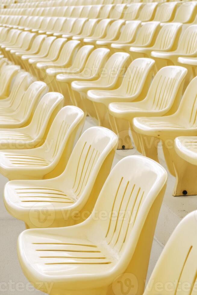 Rows of empty vintage yellow stadium seats creating a nostalgic atmosphere photo