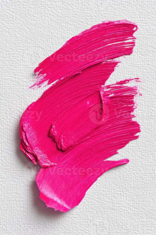 Vivid pink paint smear on monochrome canvas background creating abstract art photo