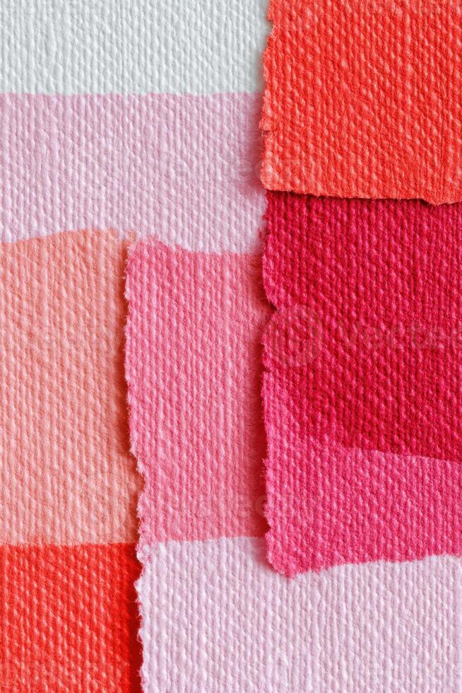 Abstract textured background with torn overlapping pink and red paper stripes creating geometric pattern photo