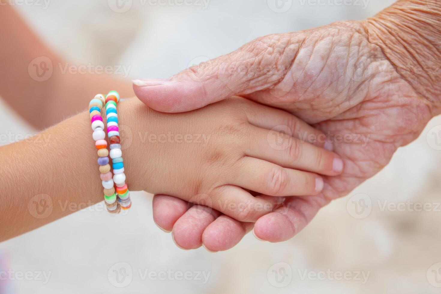 Generational Connection Through Hands and Beads photo