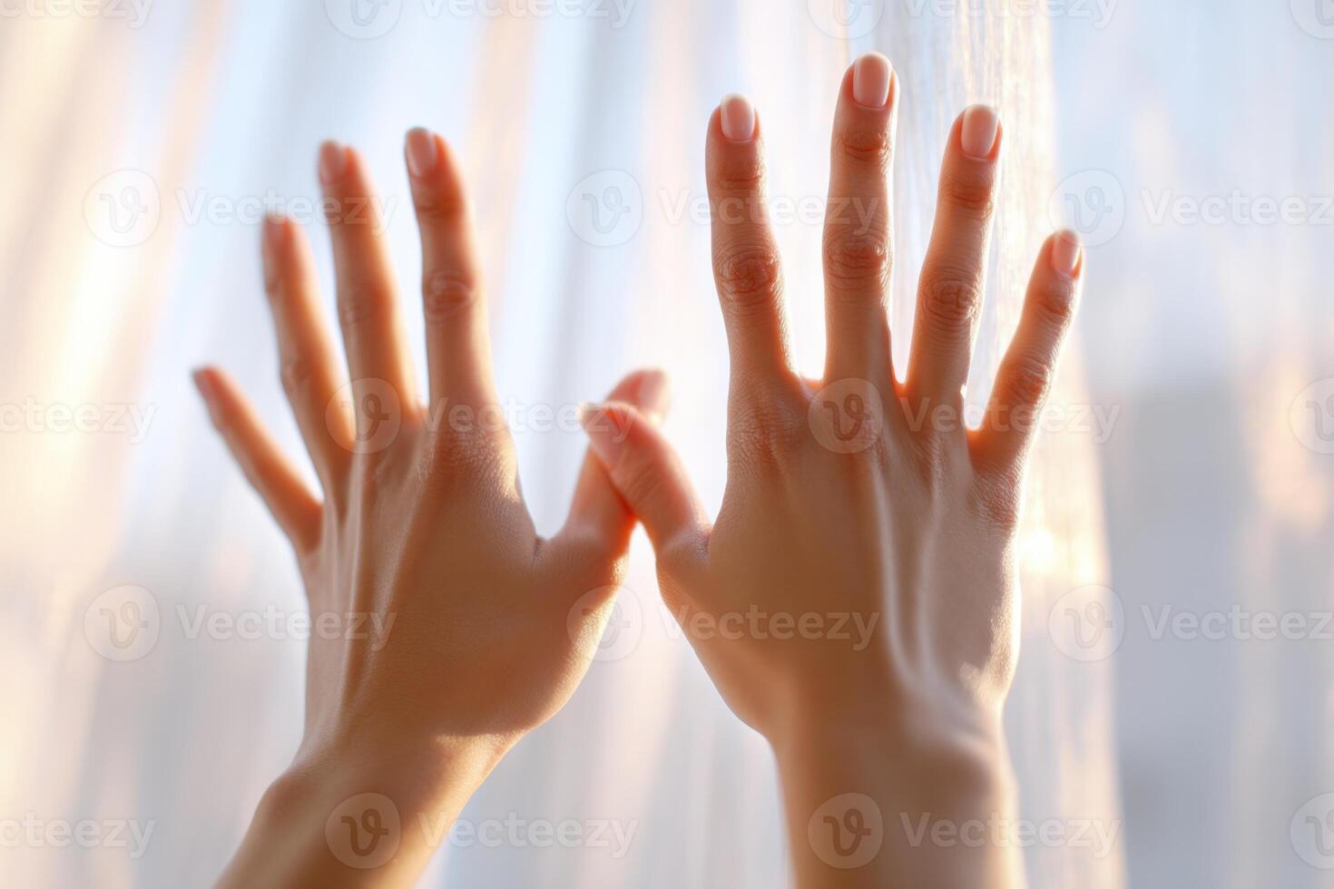Woman gently touching translucent curtain with her hands photo