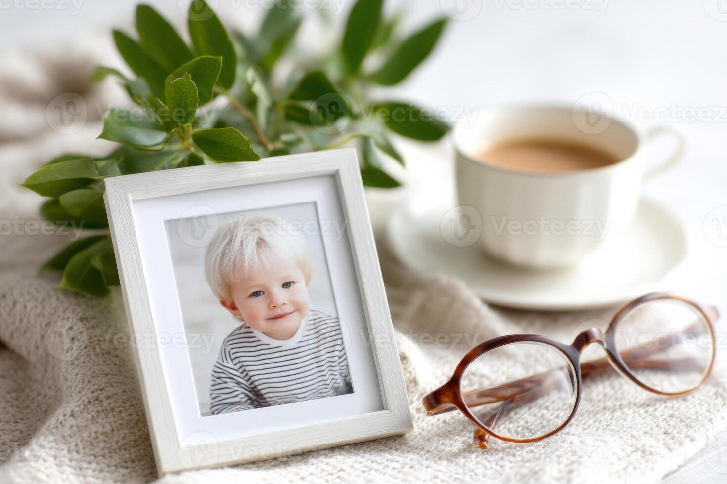 Grandchild photo in frame next to cup of tea and eyeglasses is bringing back memories