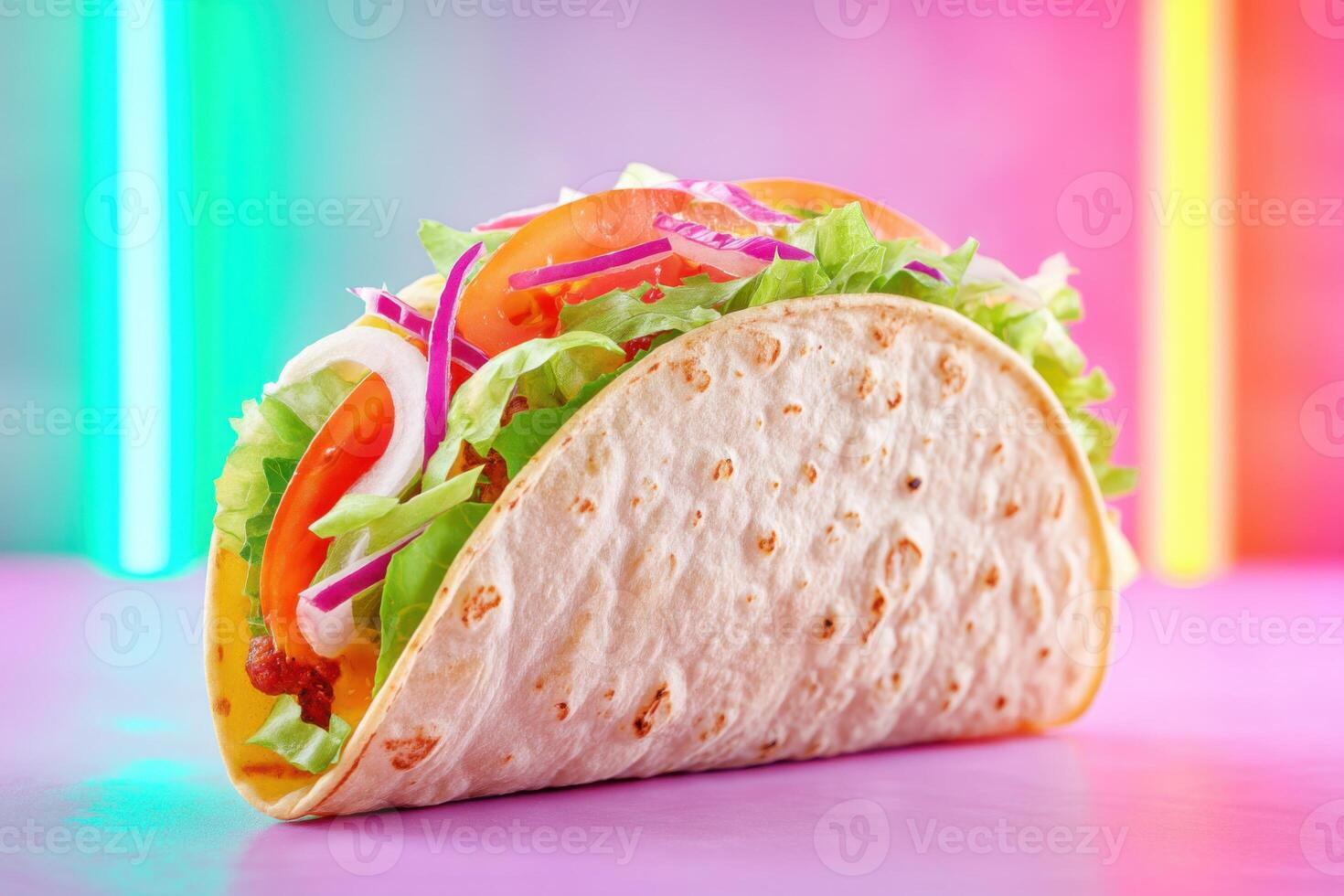 Crunchy taco with meat, lettuce, tomato, onion and colorful neon lights background photo