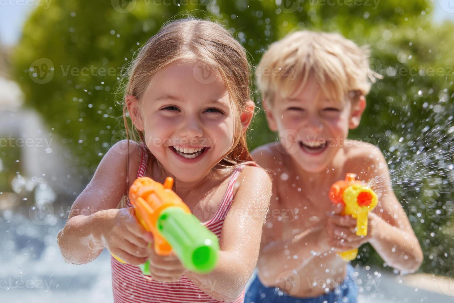 Children playing with water guns and laughing in backyard photo