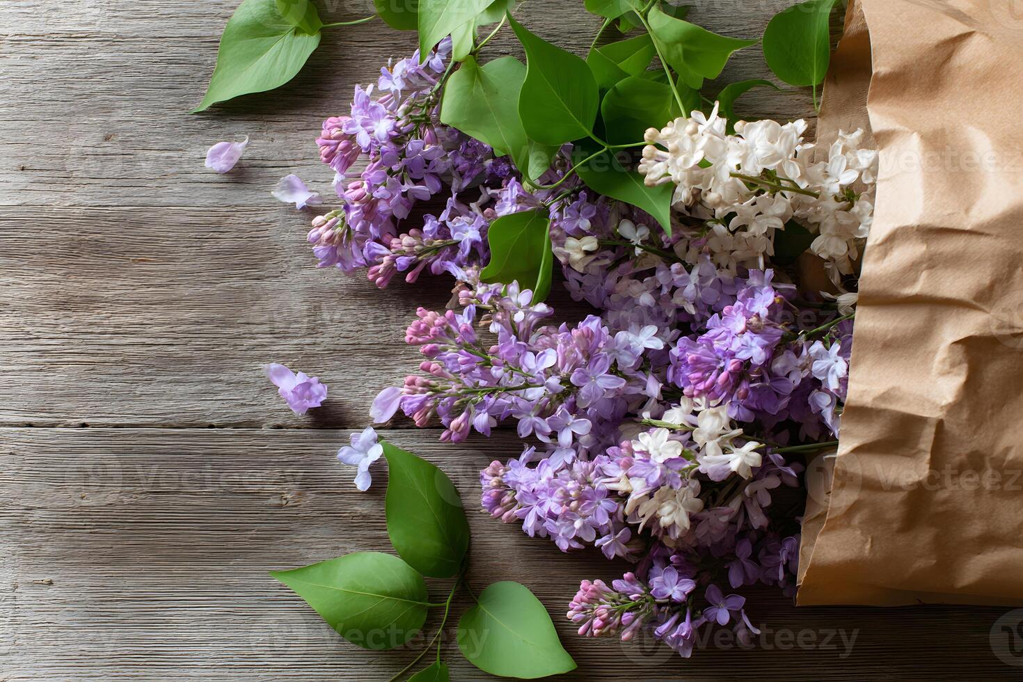Delicate lilac blooms peeking from a rustic brown paper bag on a weathered wooden surface, ready for your message. photo