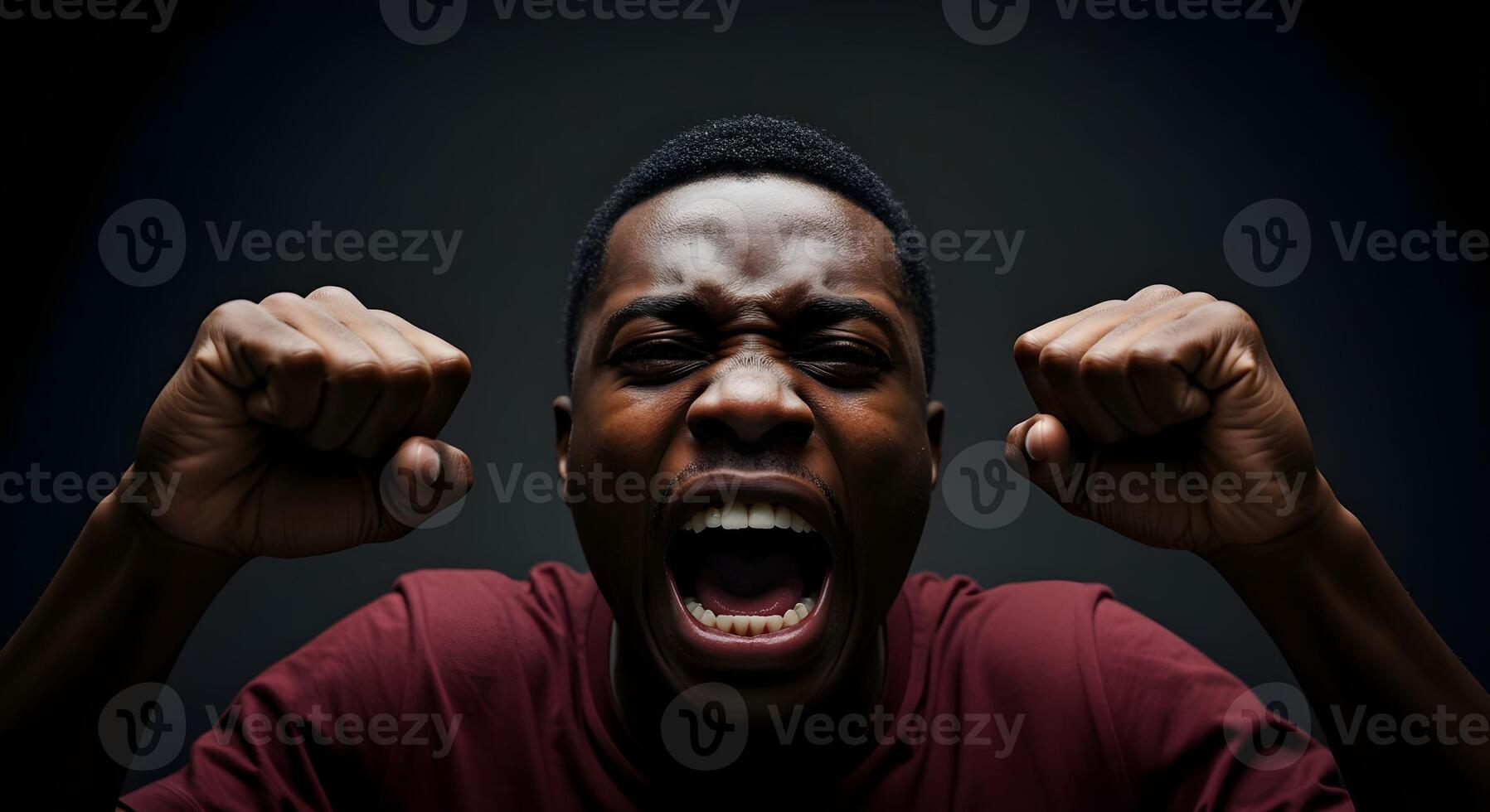 Emotionally charged moment captured in a dark setting showcasing a young man expressing intense feelings photo