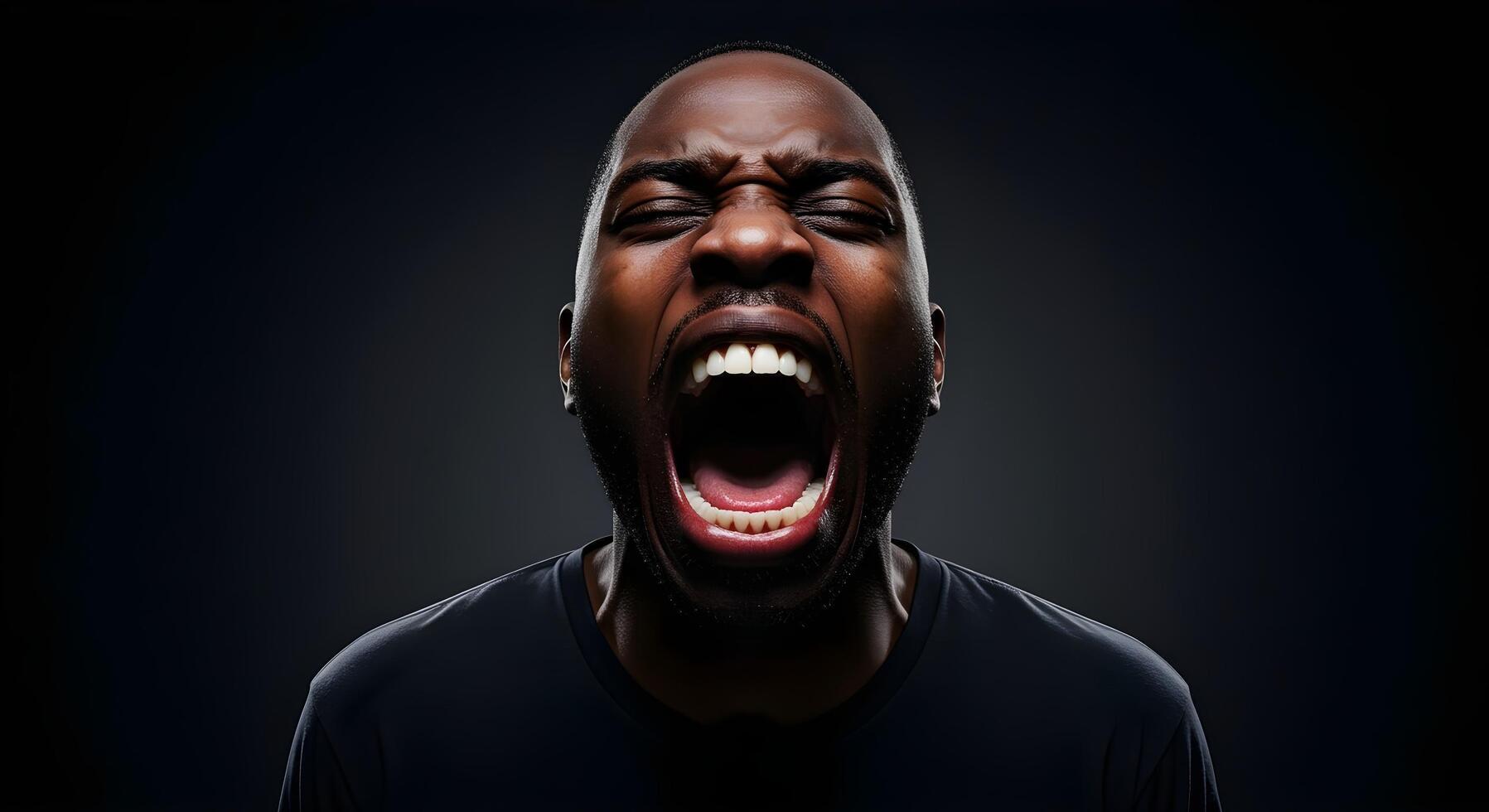Man expressing intense emotion with a loud scream in a dark setting during a moment of release photo