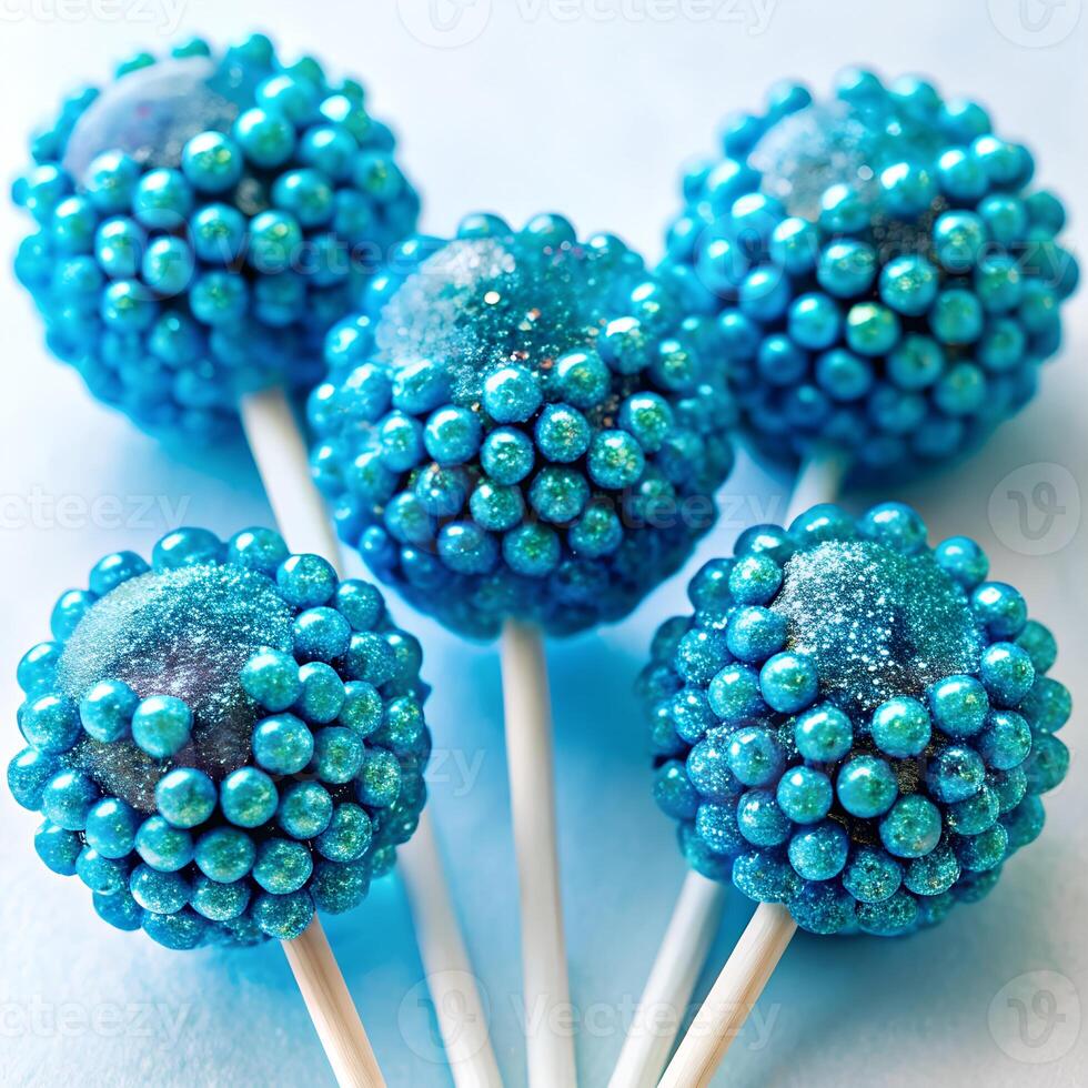 Blue raspberry lollipops with edible glitter photo