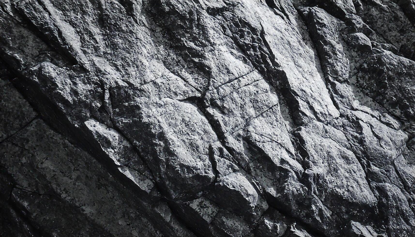 Grayscale Close-up view of rugged Textured Rocky Surface high contrast with Contrasting Patterns photo