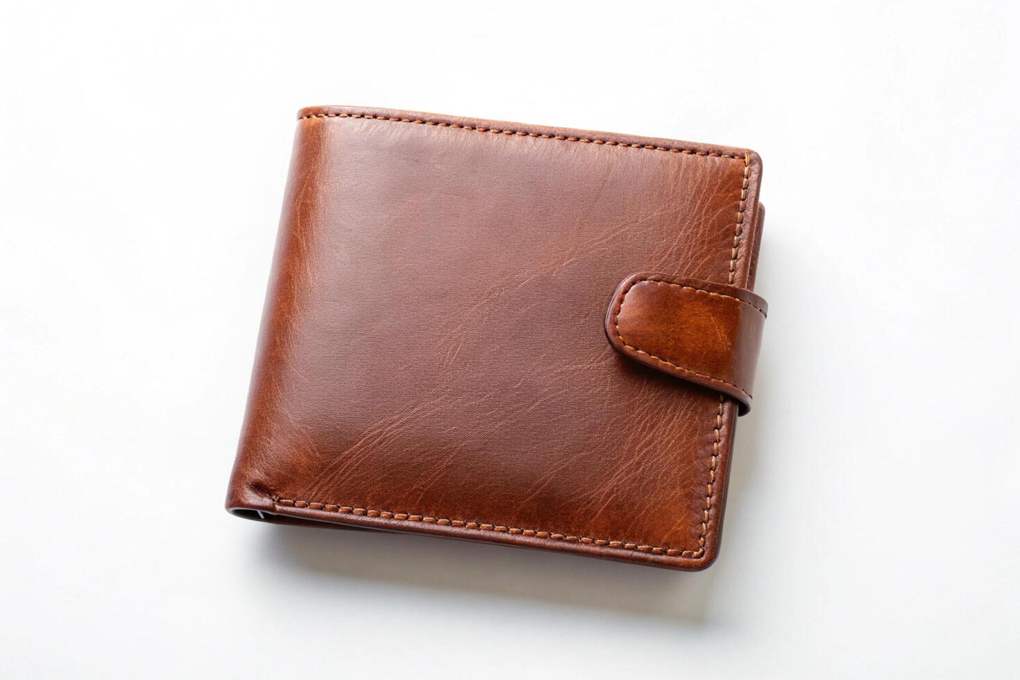 Elegant and classic brown leather wallet with visible credit cards and currency, photographed on a white background photo
