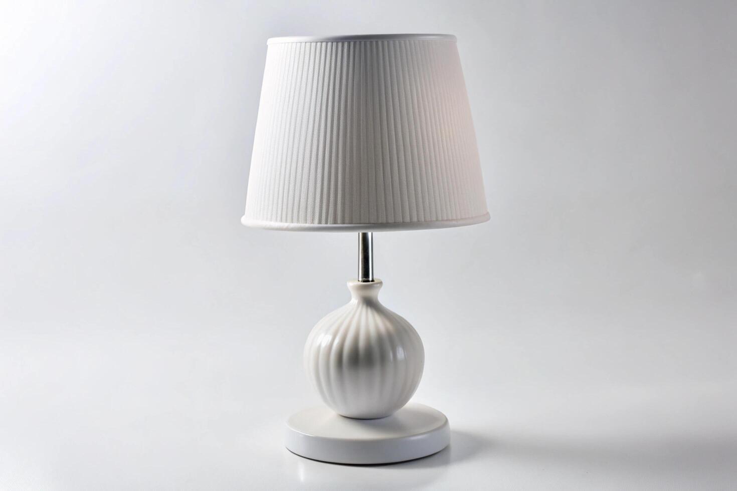Elegant white table lamp with a ribbed lampshade on a minimalistic white background, perfect for modern home decor and lighting solutions photo