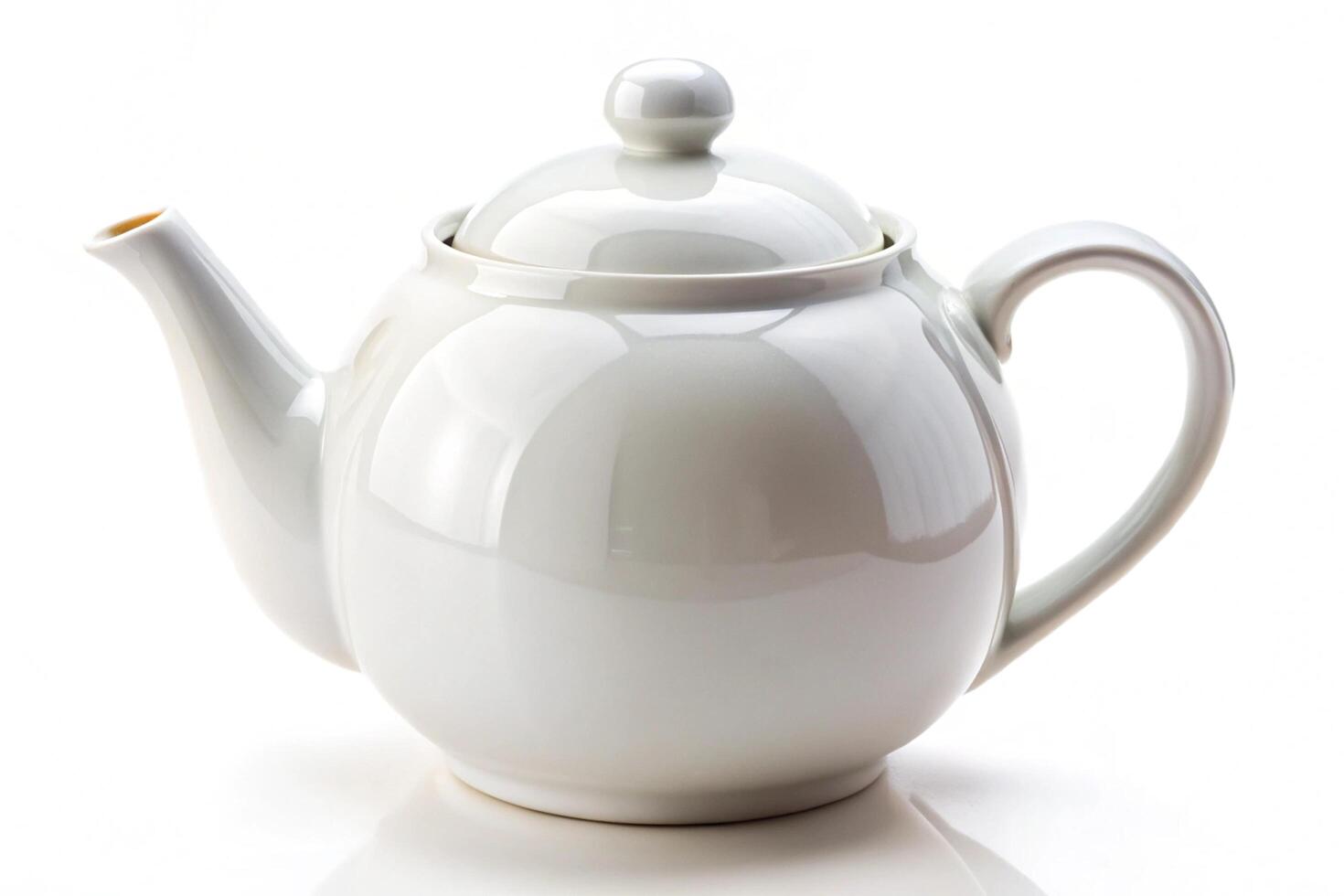 Classic white ceramic tea kettle with a minimalist design and metallic handle, offering an elegant and modern touch to any kitchen decor photo