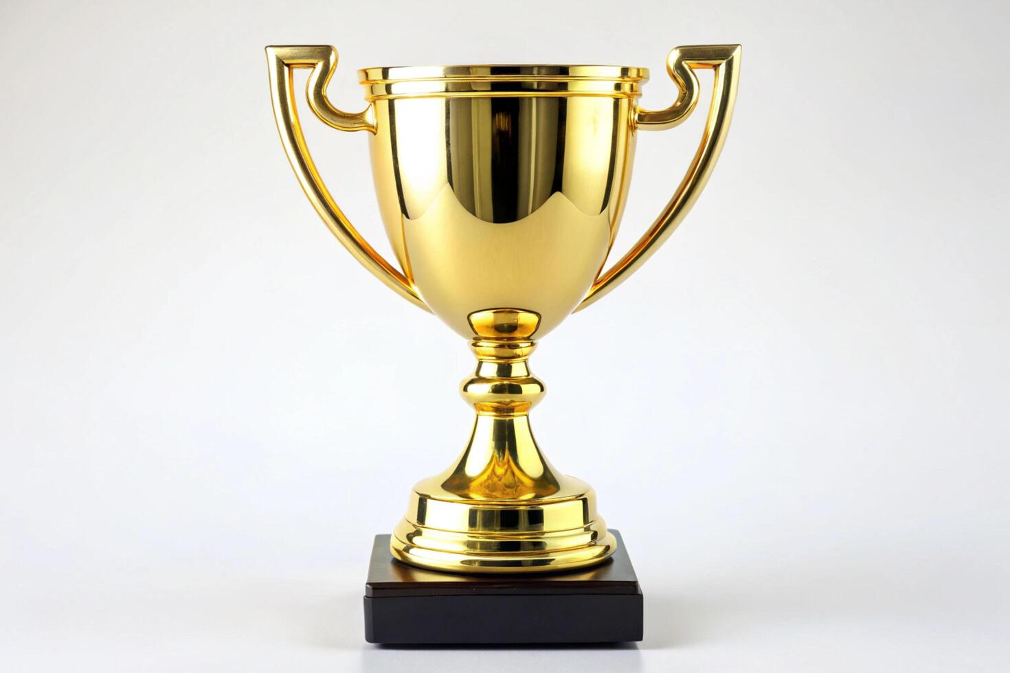 shiny gold trophy cup on a black base, symbolizing victory and achievement, isolated on a clean white background photo
