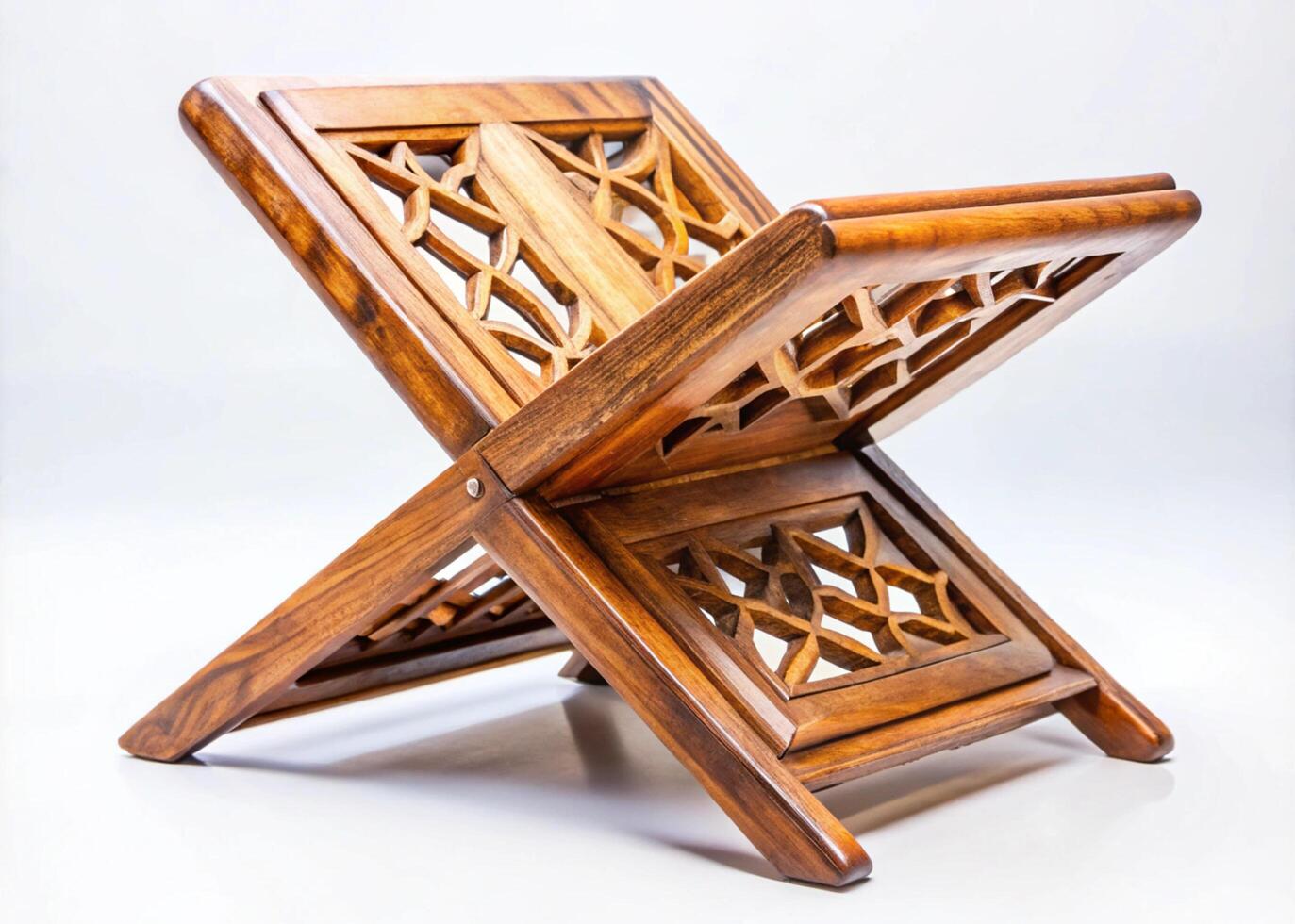 Handcrafted wooden rehal book stand with intricate carvings on a white background, perfect for reading and Islamic culture decoration photo
