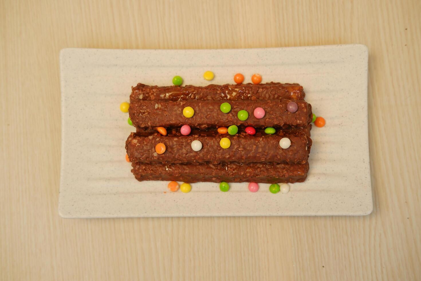 The chocolate bars appear rich and textured, possibly containing nuts or crispy rice photo