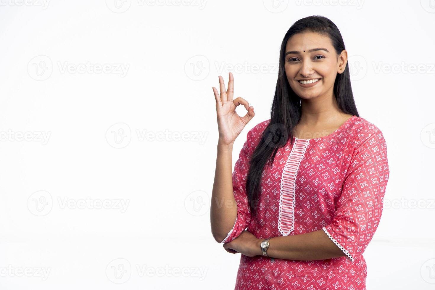 Hot Woman Posing In Studio Showing Ok Sign photo