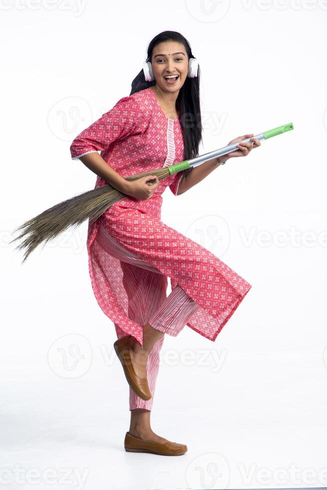 Playful Woman Playing Guitar With Broom photo