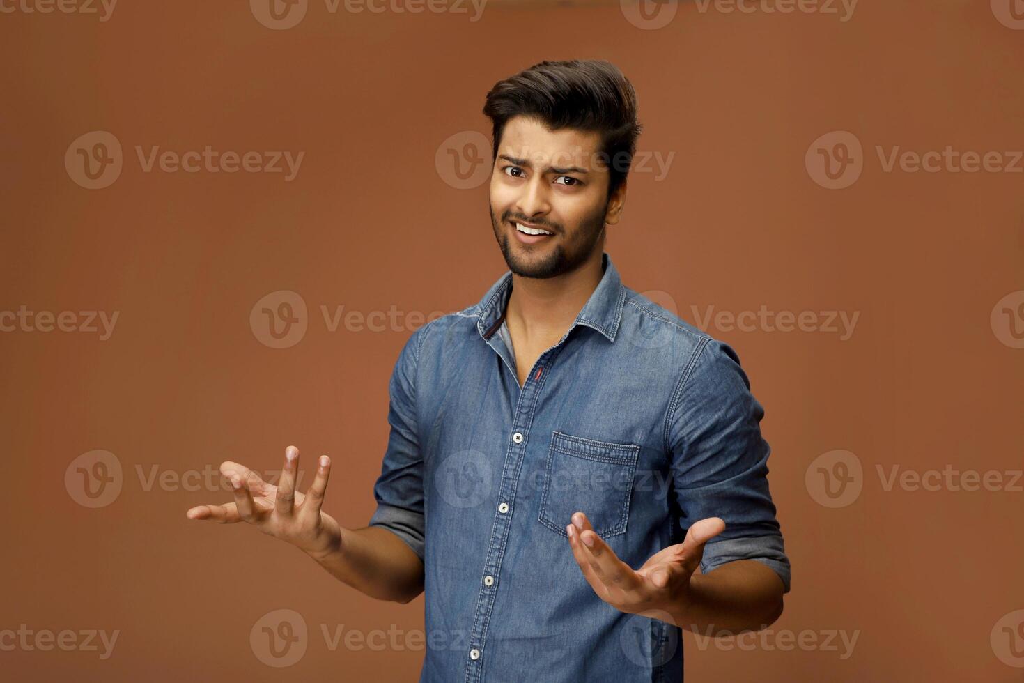 Handsome male model making a shrug gesture pose photo