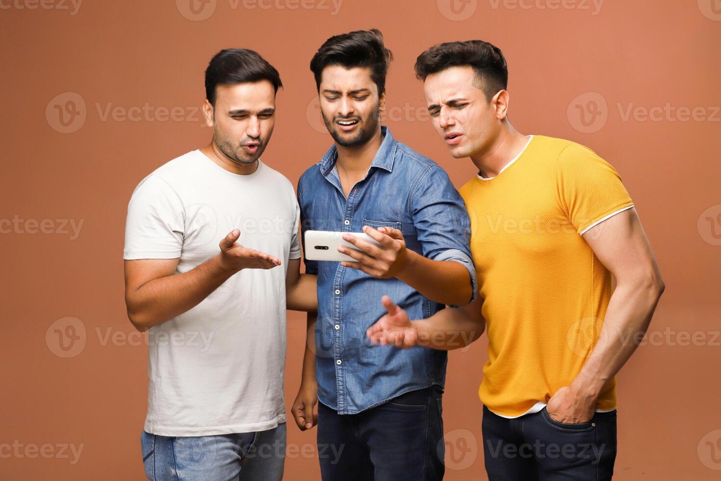 Indian male models got upset while watching a live cricket game on their mobile device due to the loss of a wicket. photo