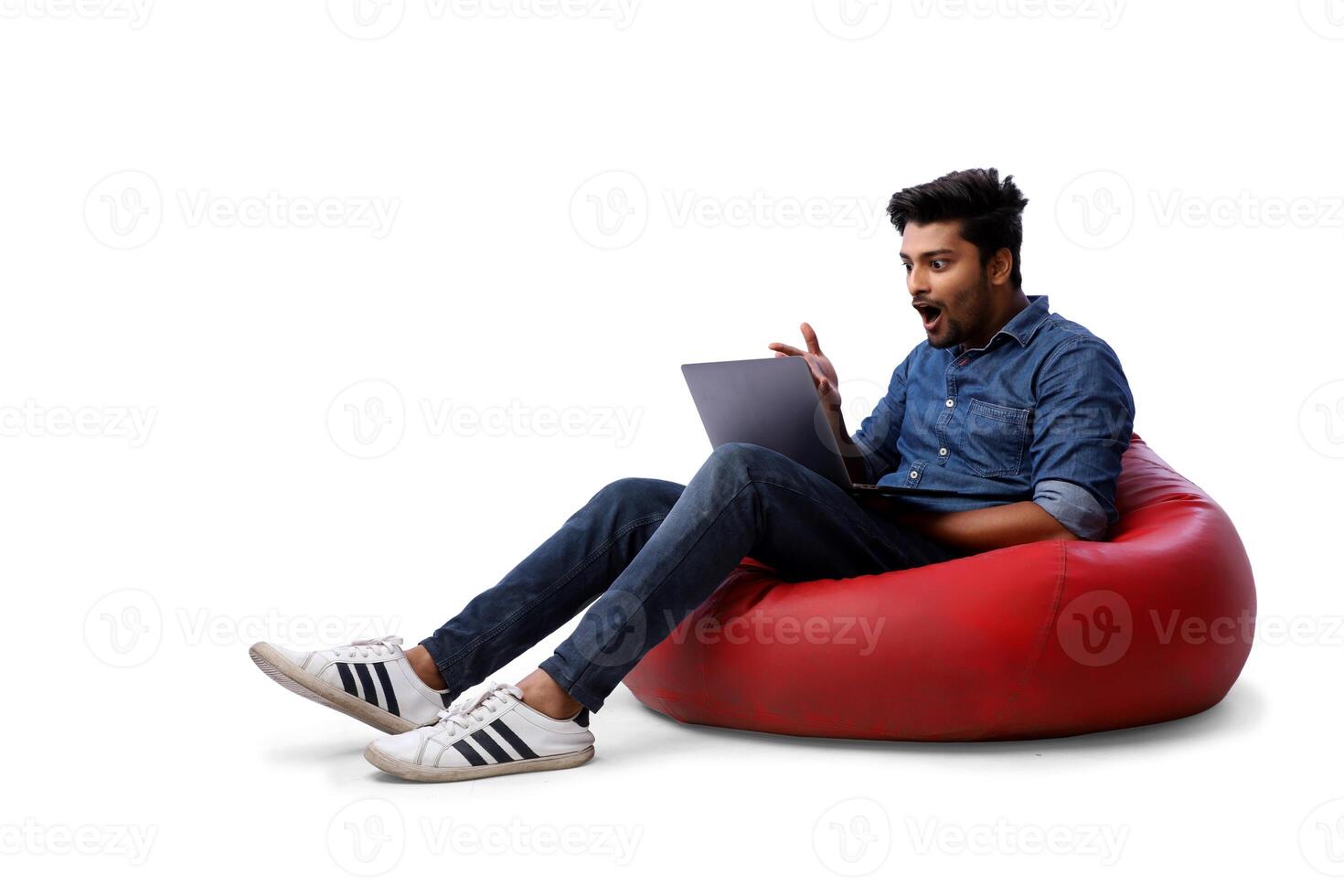 Asian model working on a laptop and sitting on a beanbag chair photo