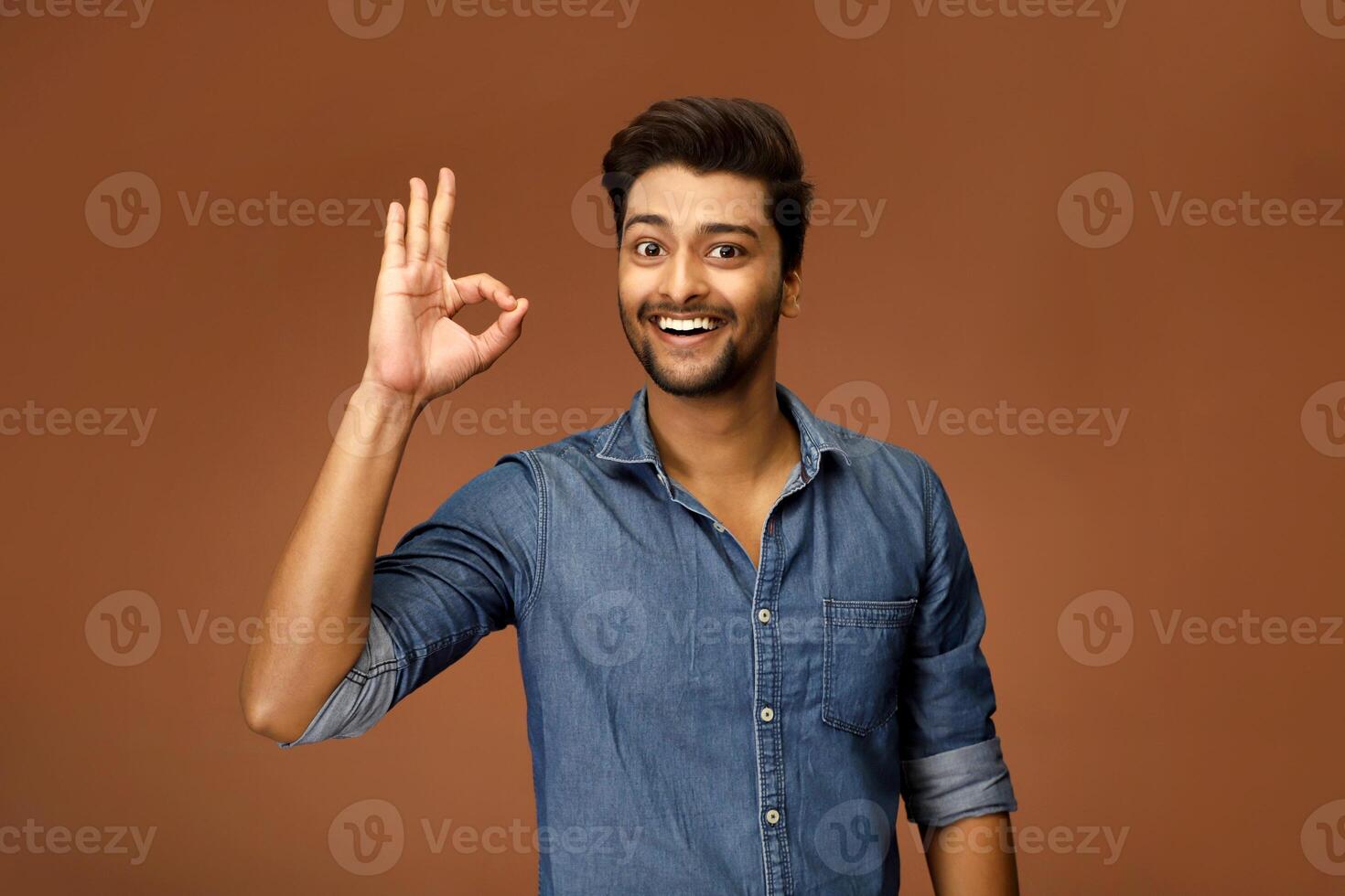 Asian male model with a smile and an OK gesture photo