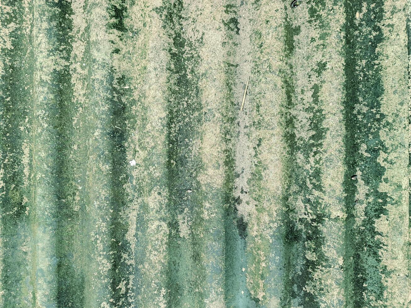 Close-Up of Corrugated Asbestos Surface with Visible Mold, Dirt, and Aging Patterns photo