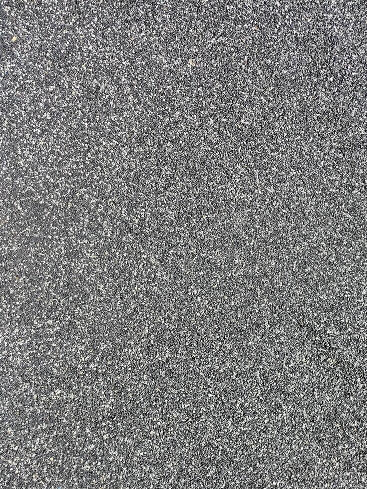 Close-up of asphalt texture showing gritty, realistic detail. Ideal for use in road designs, 3D modeling, architectural projects, and surface simulations for urban or outdoor settings photo