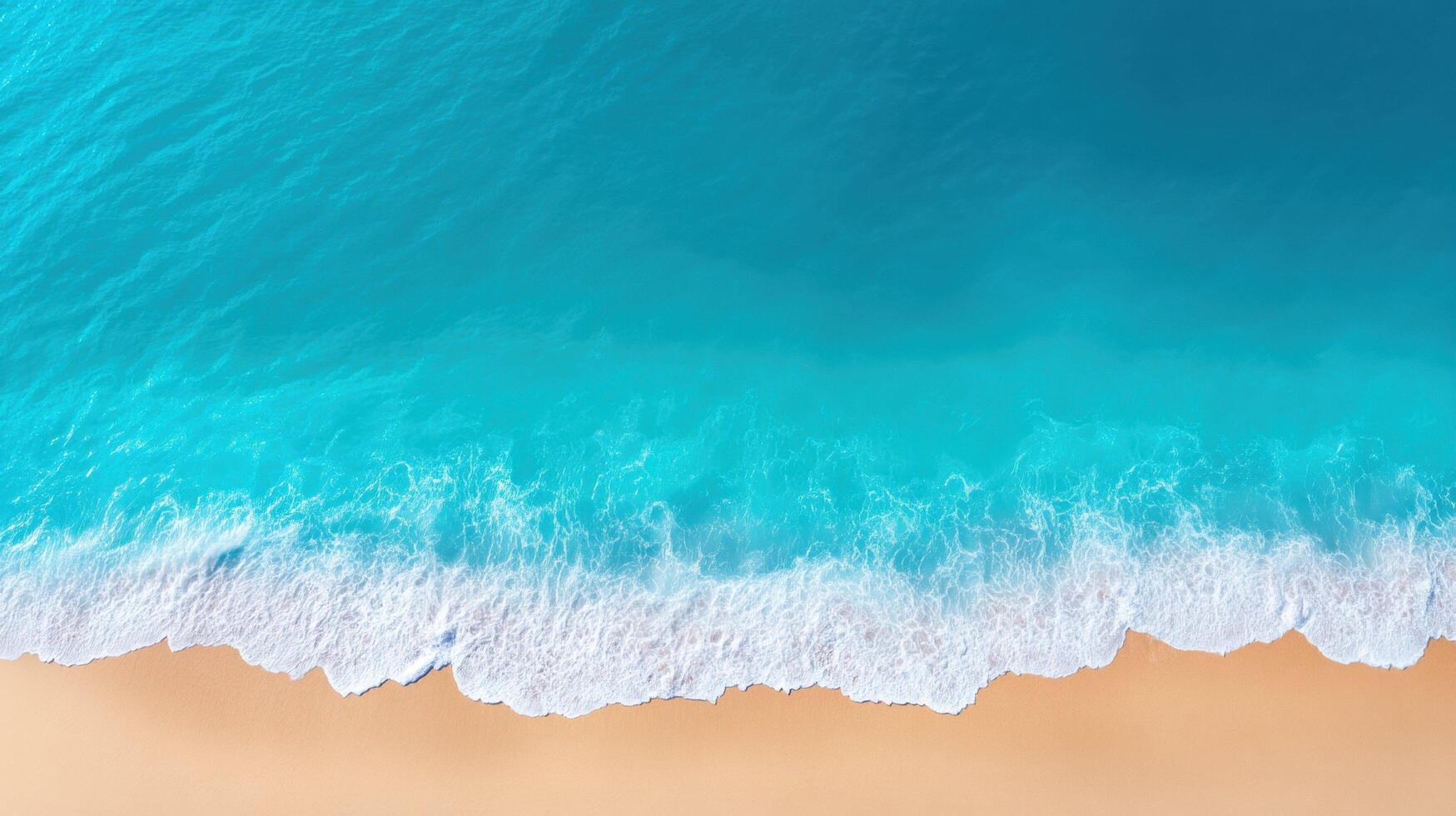 Top view of turquoise ocean waves on sandy beach with white foam, bright water, and smooth shoreline under daylight. photo