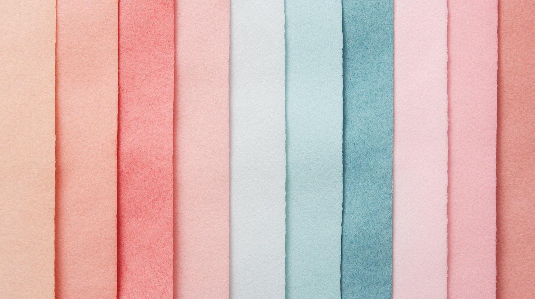 Pastel Colored Textured Paper Sheets Neatly Aligned Vertically featuring soft tactile surfaces and multiple warm hues arranged in an organized row. photo