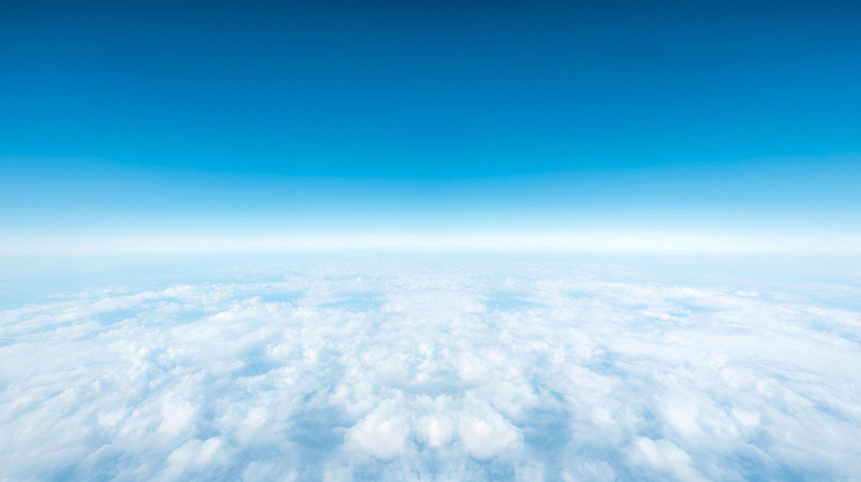 Blue Sky Over Soft White Cloudscape showing a serene and expansive aerial view with clear atmosphere and calm light from high altitude. photo