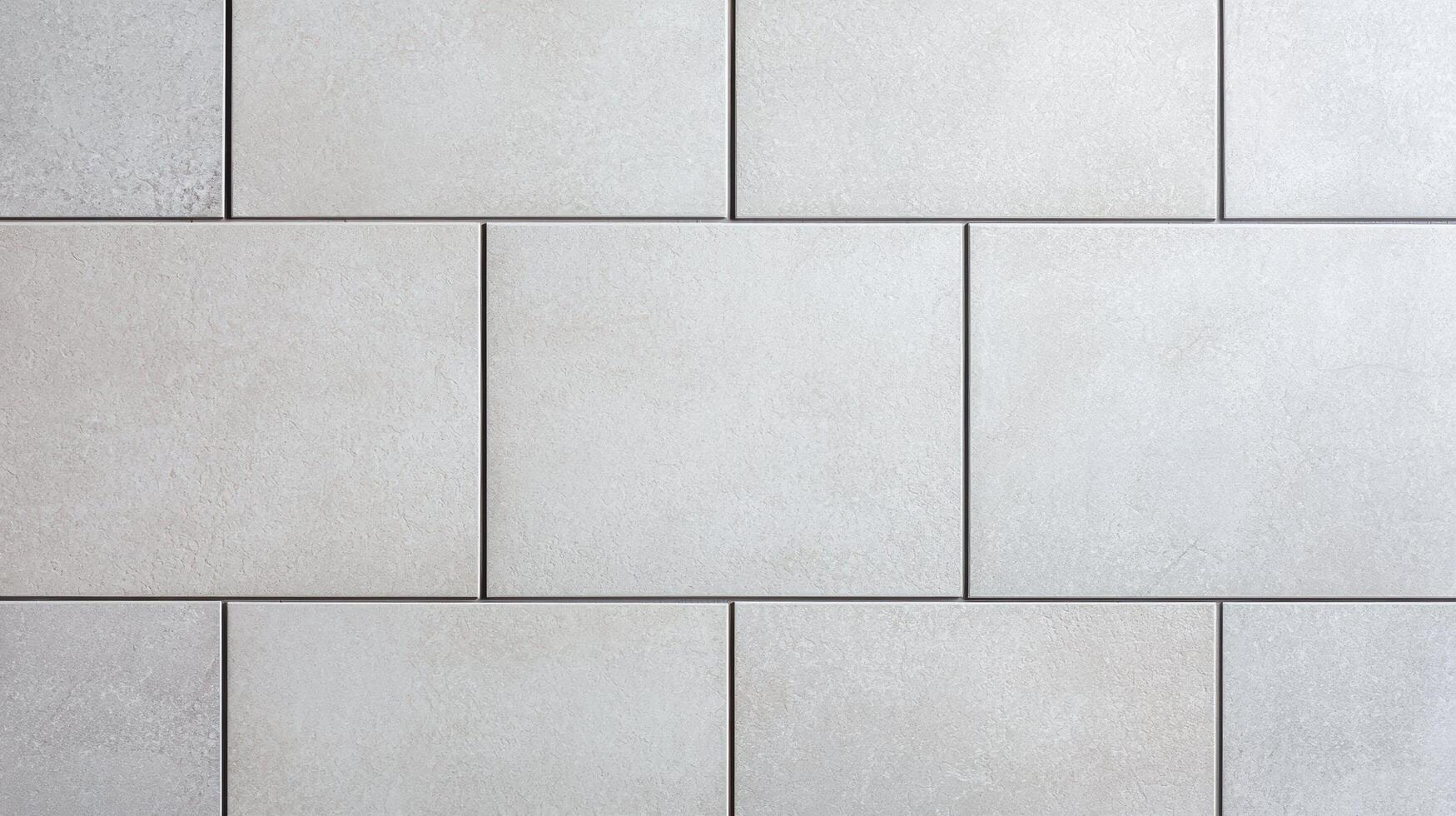 Light gray square ceramic tile wall texture featuring clean grout lines, subtle surface grain, and minimal geometric design ideal for flooring, walls, or architectural backgrounds. photo