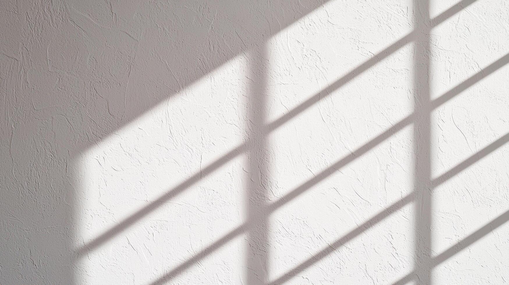 White plaster wall with harsh shadow lines cast by window creating contrast between textured surface and bright minimalist background. photo
