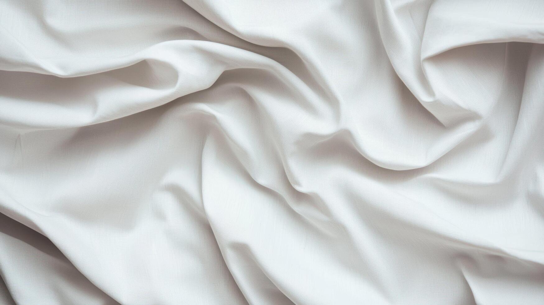 White wrinkled fabric with soft folds and subtle texture creating a smooth and elegant appearance for textile or design backgrounds. photo