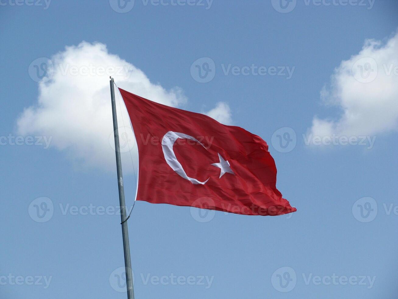 Turkish flag on a blue sky photo