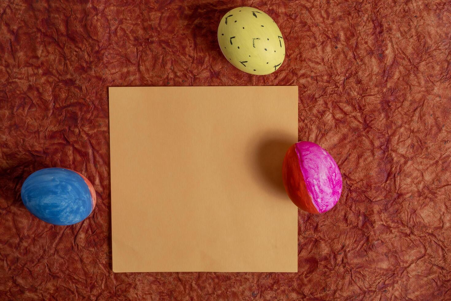 Colorful Easter eggs, texture background with blank paper photo