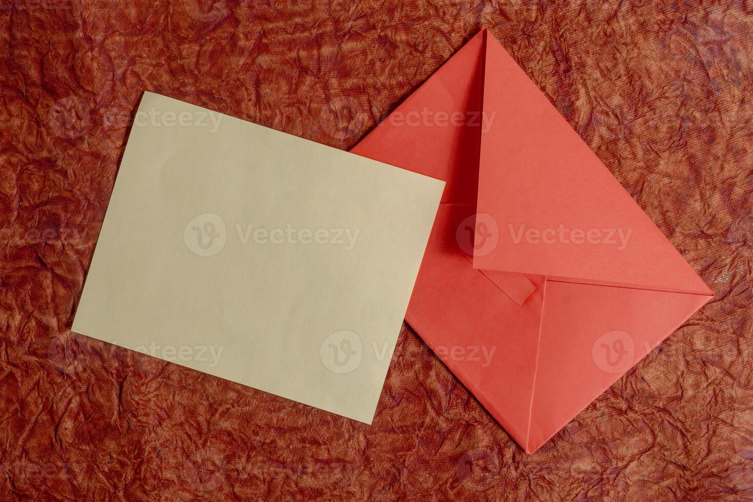 Elegant minimalist envelope and blank card on a red background. photo