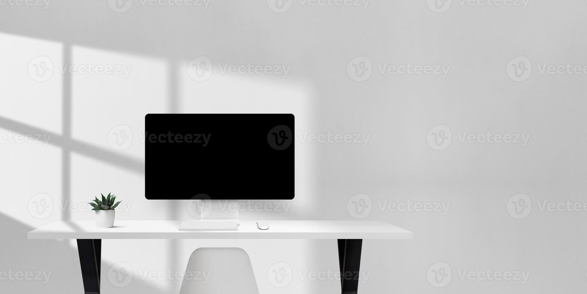 Bright office desk with computer monitor, keyboard, mouse, and plant, clean workspace with empty space on the right for copy or branding photo