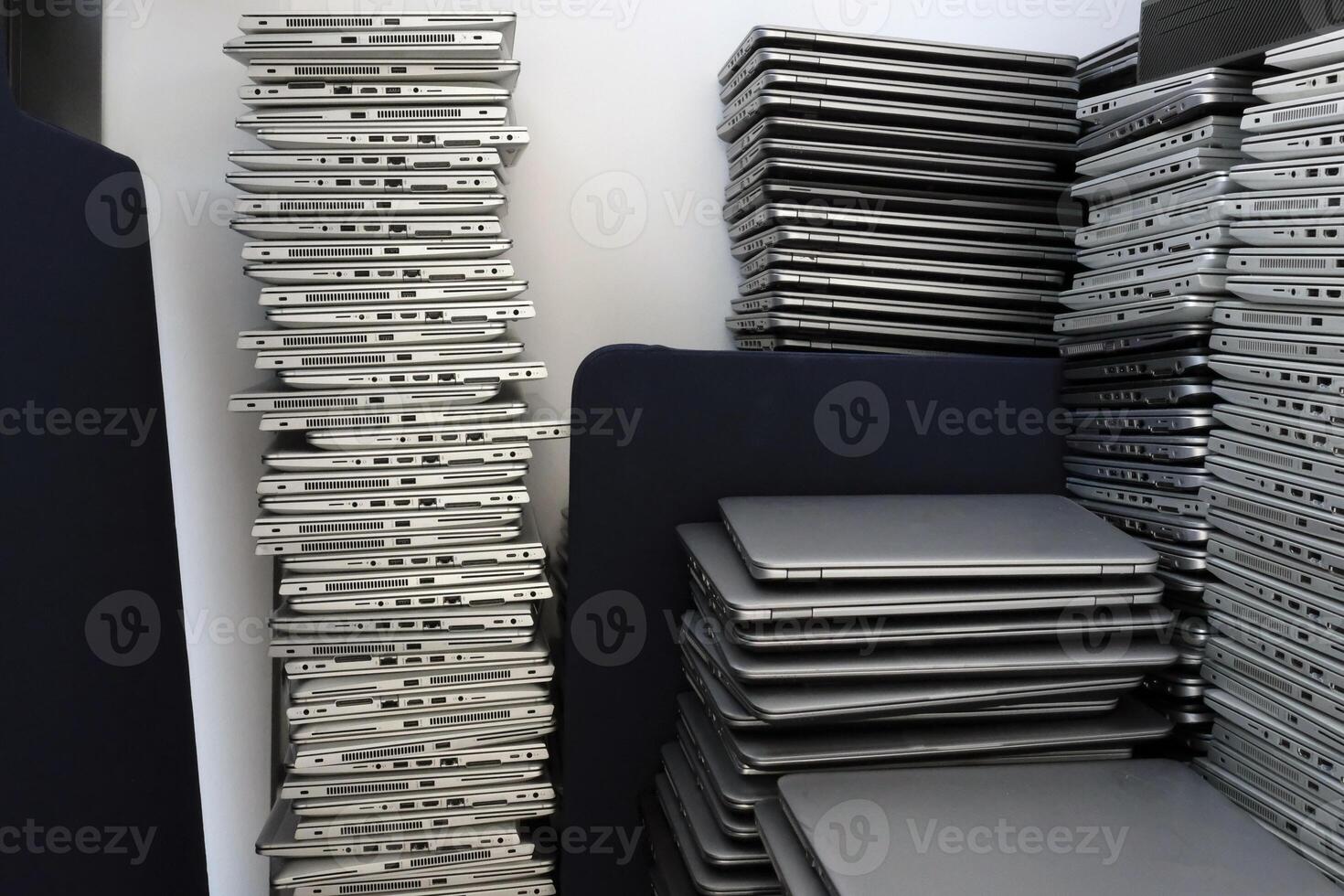 Many stacks of laptops in the storage room of a company photo