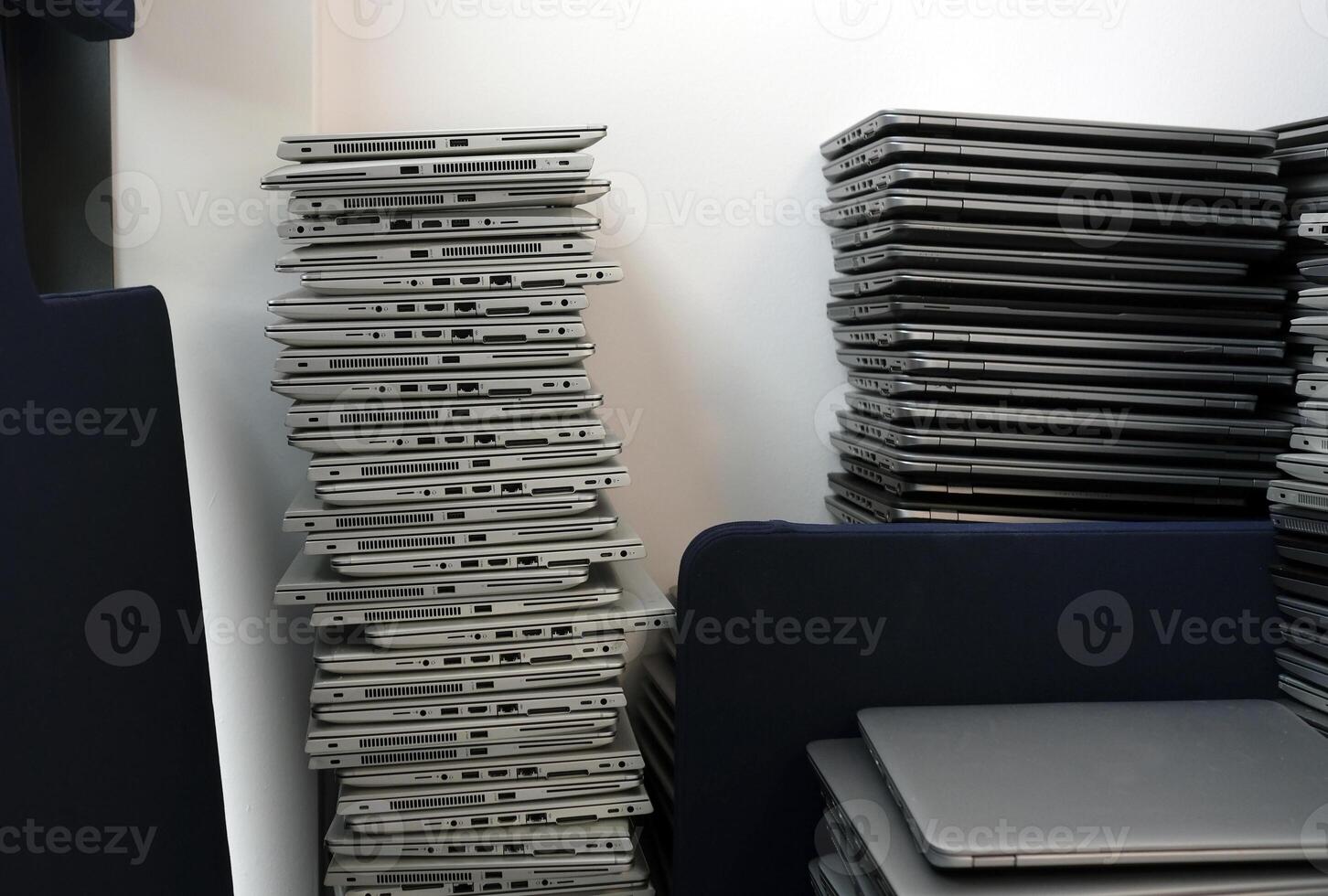 E-waste - big stacks of laptops to be discarded photo