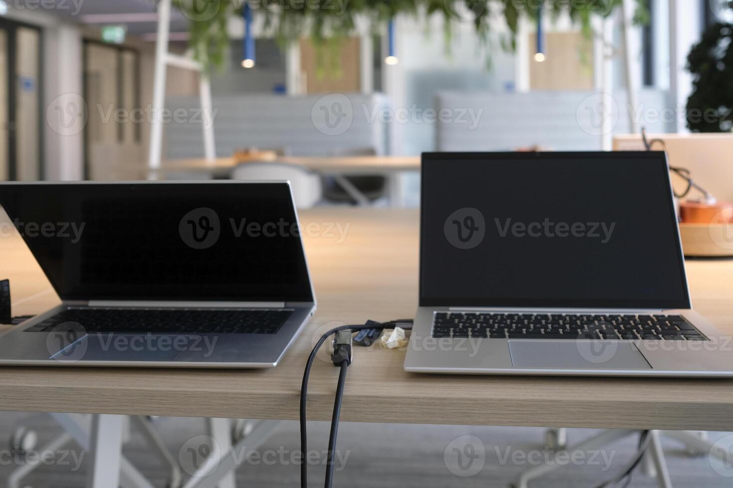 Table with laptops being prepared and set up for new employees in a company photo