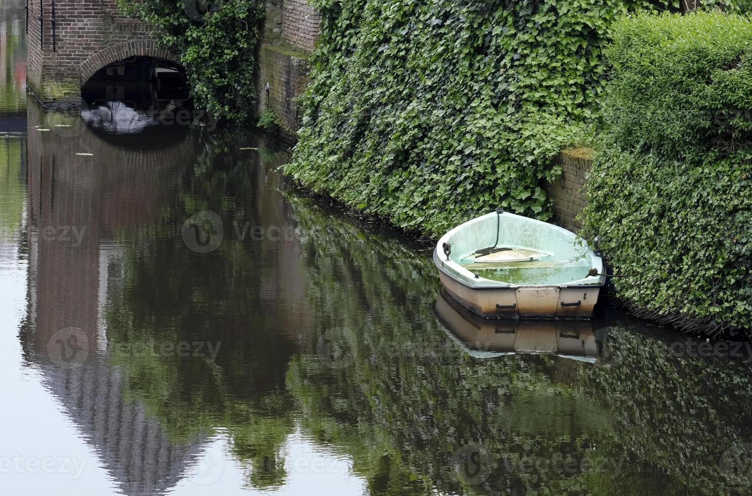 Abandoned rowboat on a canal in Amersfoort, Netherlands photo