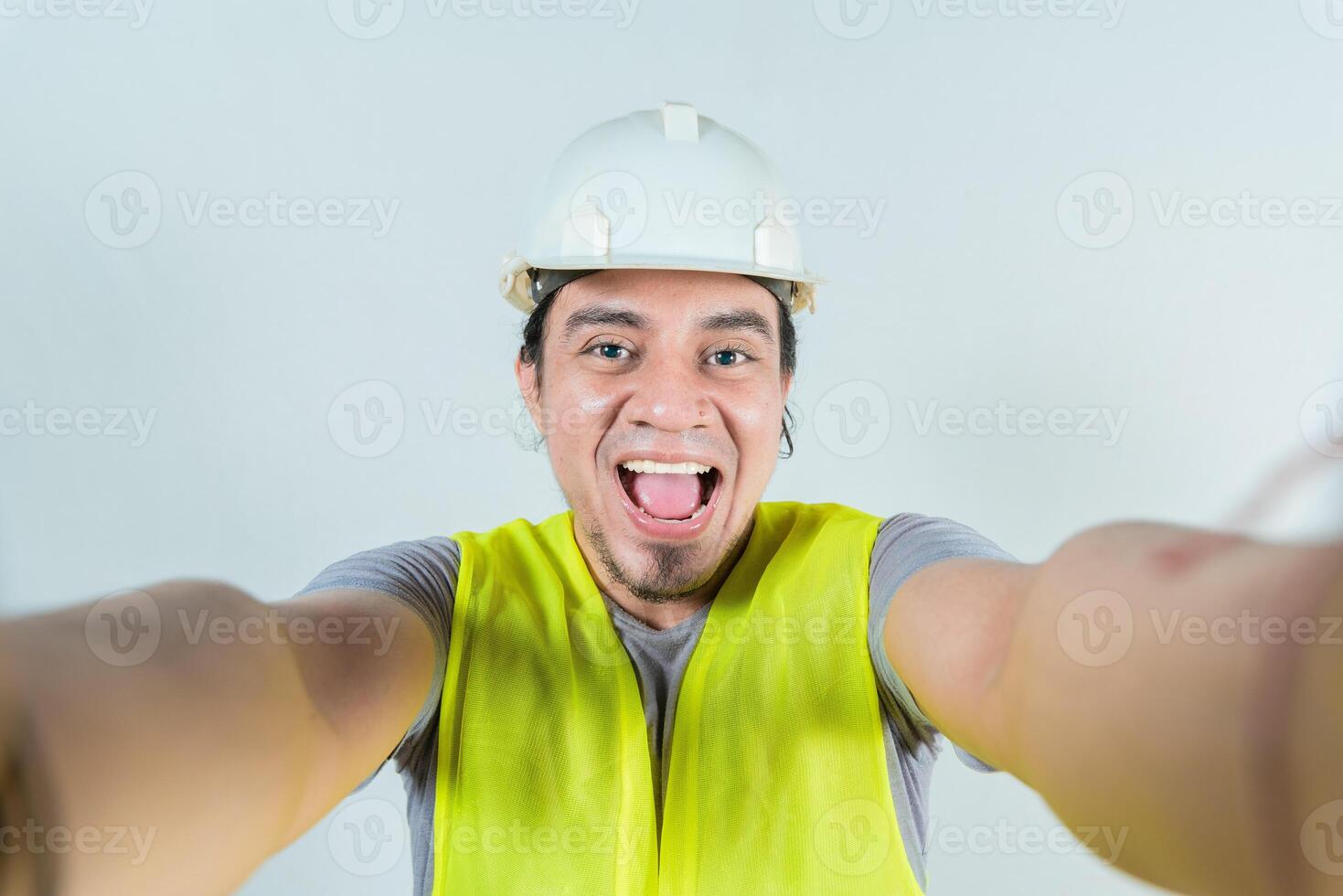 Funny builder engineer taking a selfie isolated, Engineer taking a selfie isolated. View of male engineer taking a selfie. Smiling male engineer taking a selfie looking at camera photo