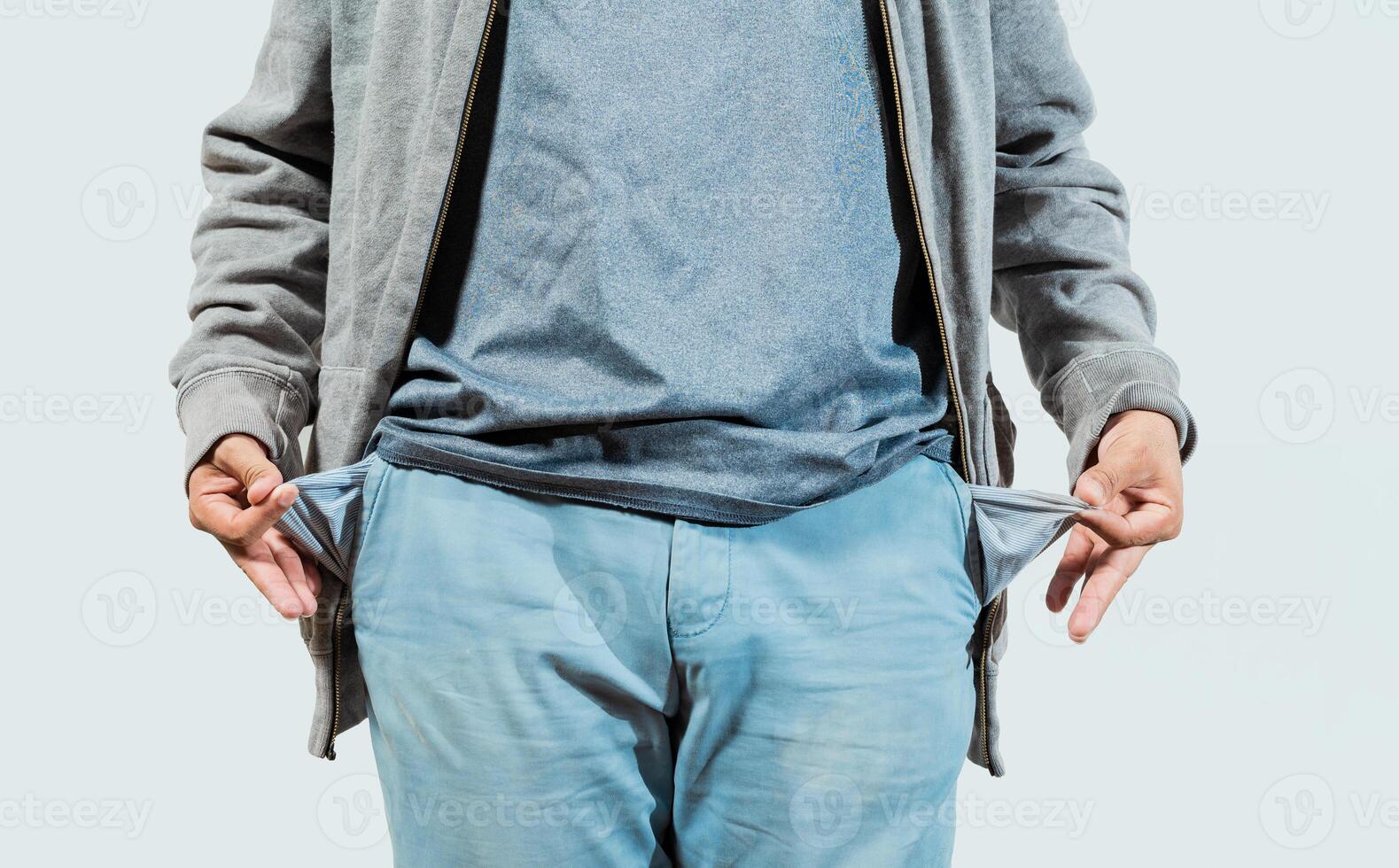 Closeup of person with empty pockets isolated. Concept of poverty and economic crisis photo