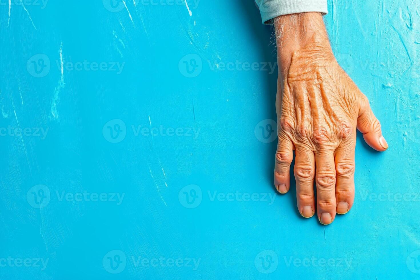 A person's hand on a blue wall photo