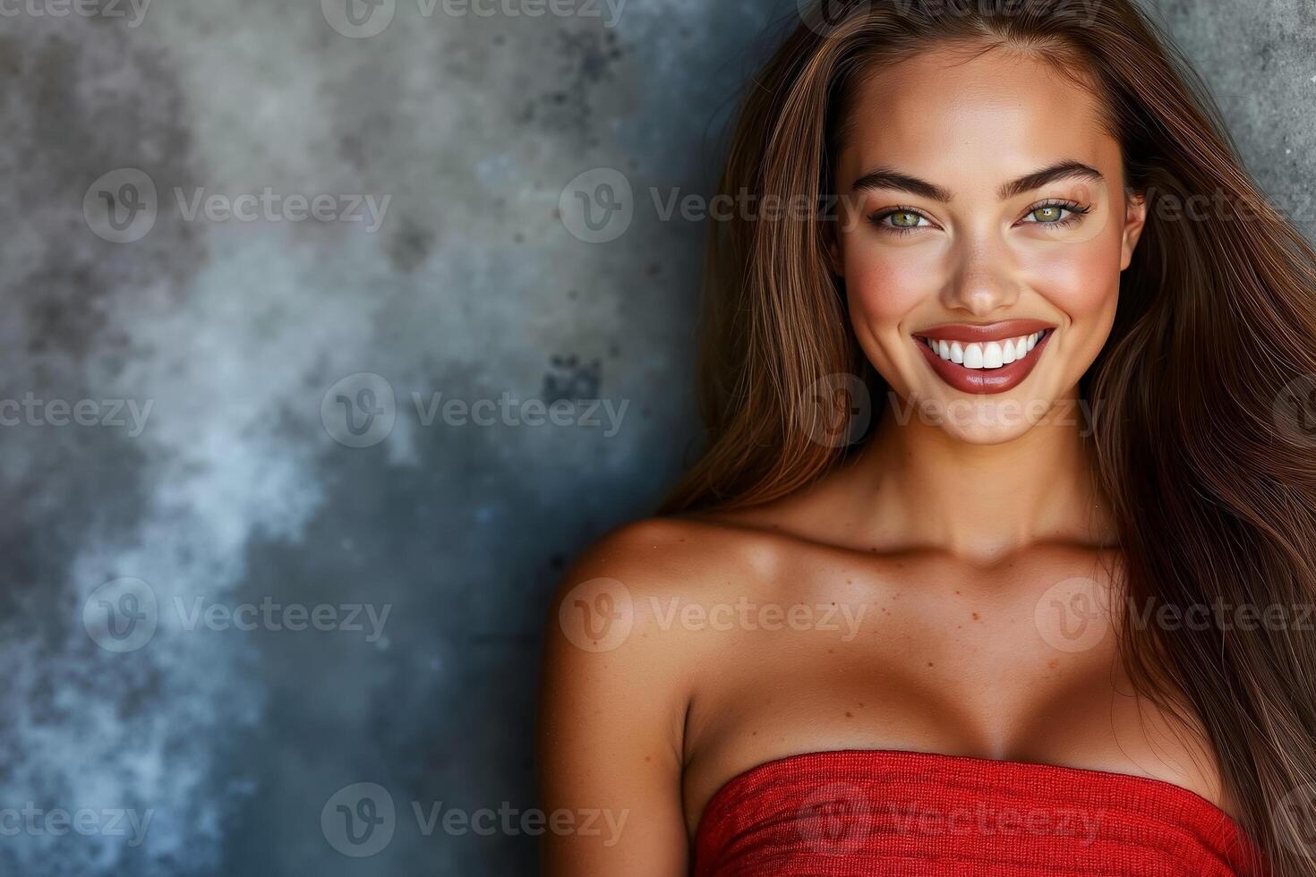 A woman in a red dress smiling at the camera photo